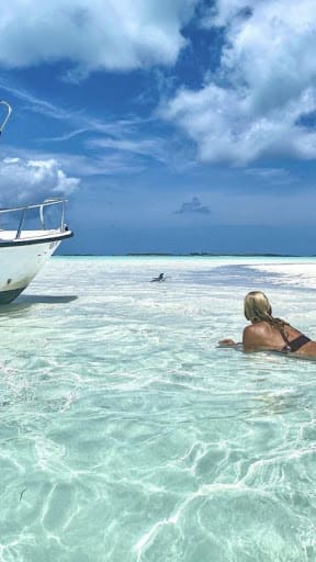 Bright blue sky with clouds and crystal clear ocean water